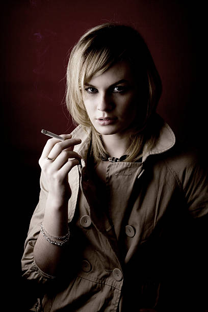 Woman Private Investigator Smoking a Cigarette stock photo
