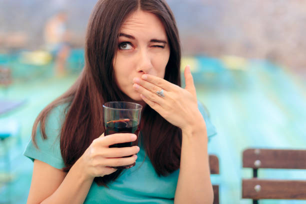 Woman Reacting after Having a Fizzy Soda Drink Funny female customer in a restaurant having a carbonated beverage hiccup stock pictures, royalty-free photos & images