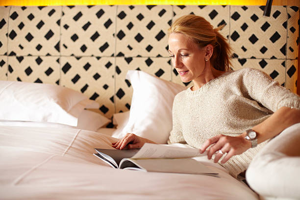 Woman reading magazine on bed  lech valley stock pictures, royalty-free photos & images
