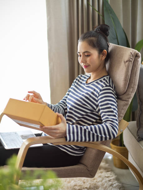 Woman receiving her package from an online shopping store stock photo