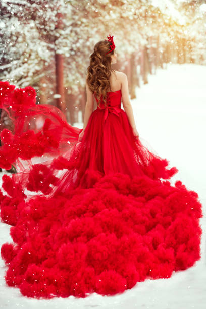Woman Red Dress and Winter Snow, Fashion Model in Ruched Waving Gown, Rear View Woman Red Dress and Winter Snow, Fashion Model in Ruched Fluffy Waving Gown, Rear Back View in Forest evening gown stock pictures, royalty-free photos & images