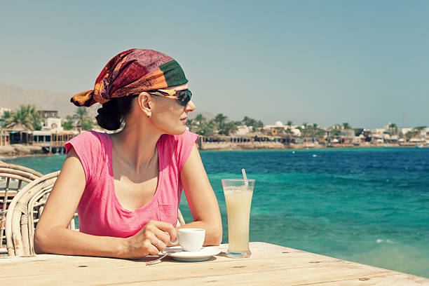 woman relaxing at a seaside cafe  hot egyptian women stock pictures, royalty-free photos & images