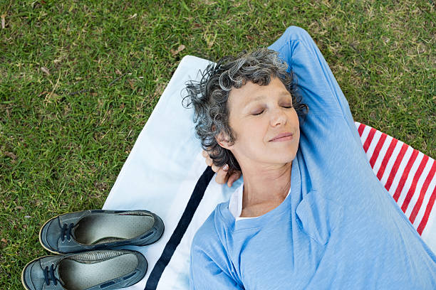 woman relaxing at park - nap middle age woman bildbanksfoton och bilder