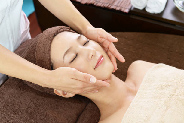 Woman relaxing with facial massage Woman relaxing with facial massage beauty spa stock pictures, royalty-free photos & images