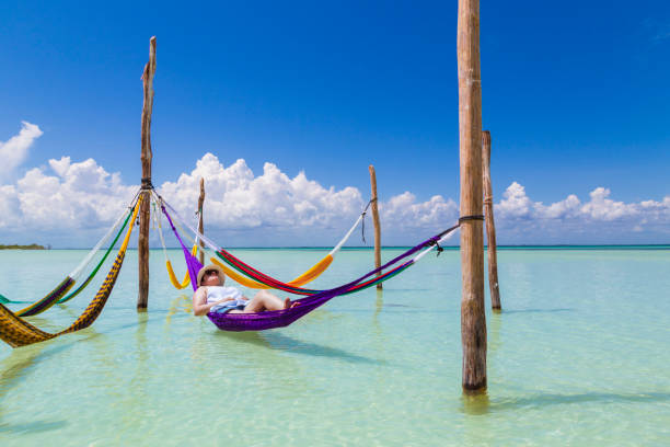 Woman resting in a hammock at the Caribbean island of Holbox stock photo