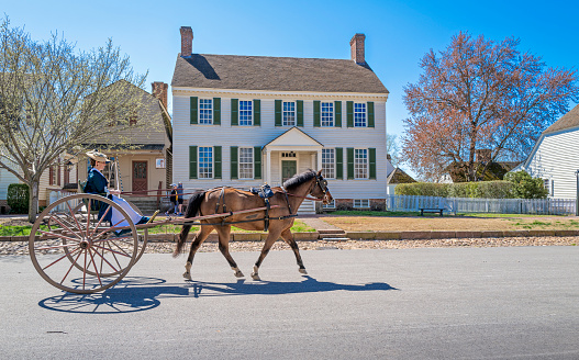Williamsburg, Virginia, USA: 29th March 2021; Woman riding on a horse and buggy in colonial Williamsburg