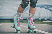istock Woman rollerskater wearing knee protector pads 1212159946