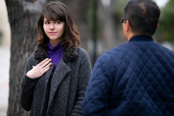 Woman Running Into an Ex Boyfriend or Insulted By Stranger Woman walking outdoors in the city and looking snobby while running into an ex boyfriend or looking annoyed by an insulting stranger.  It also depicts social anxiety. ex boyfriend stock pictures, royalty-free photos & images