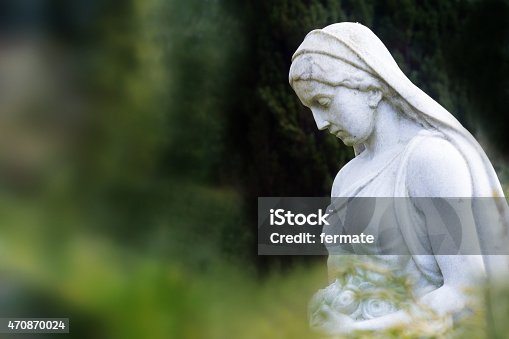 istock woman sculpture of marble in a park or cemetery 470870024