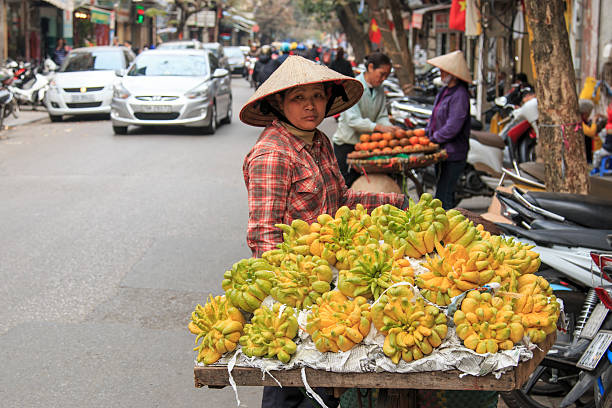 Woman selling Buddha's hand Lemons in a street of Hanoi stock photo