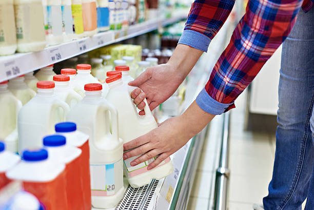 Woman shopping milk in store stock photo