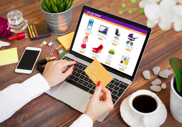 Woman shopping online on laptop and paying for purchased goods by credit card Woman shopping online on laptop and paying for order by credit card amazon shop page images stock pictures, royalty-free photos & images