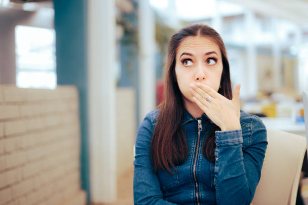 Woman Sitting in a Restaurant Feeling Sick and Nauseated stock photo