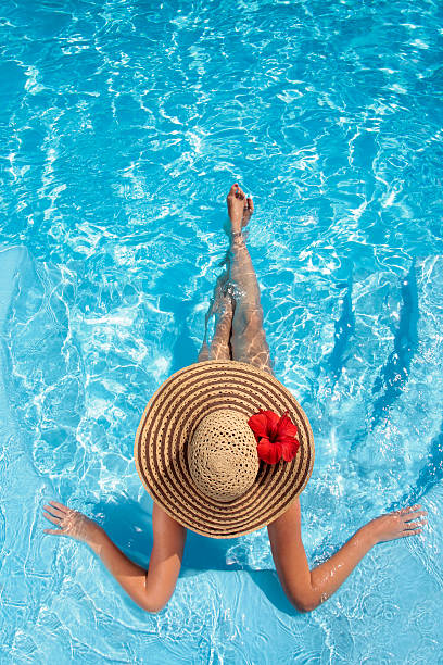 Woman Sitting in a Swimming Pool stock photo