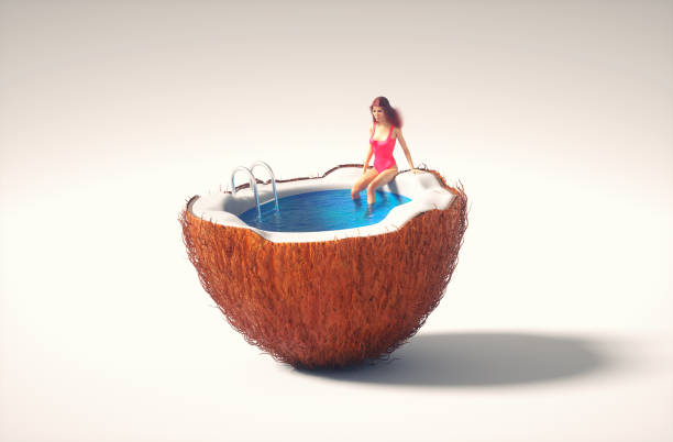 Woman sitting on a half coconut  pool. stock photo