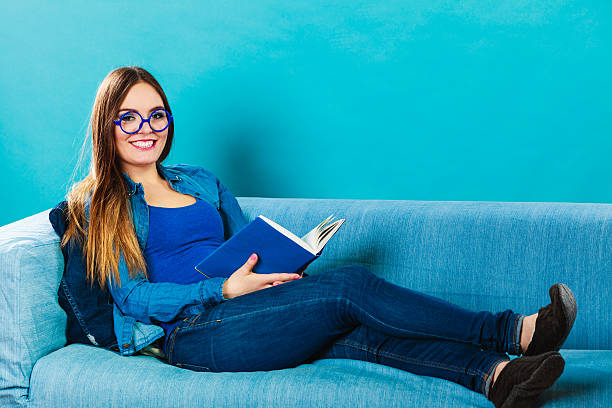 Leisure, education, literature and home concept - Woman in glasses...