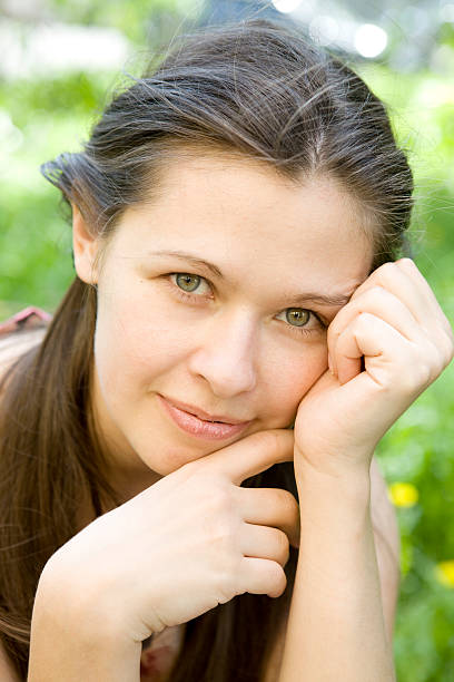woman sitting on the grass stock photo