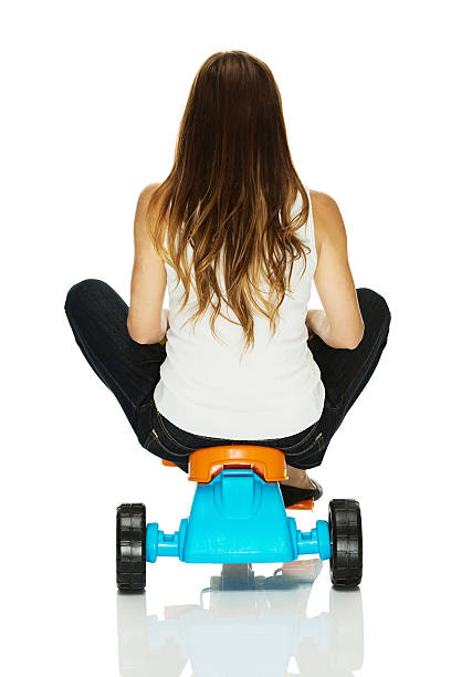 Woman sitting on tricycle Woman sitting on tricyclehttp://www.twodozendesign.info/i/1.png adult tricycle stock pictures, royalty-free photos & images