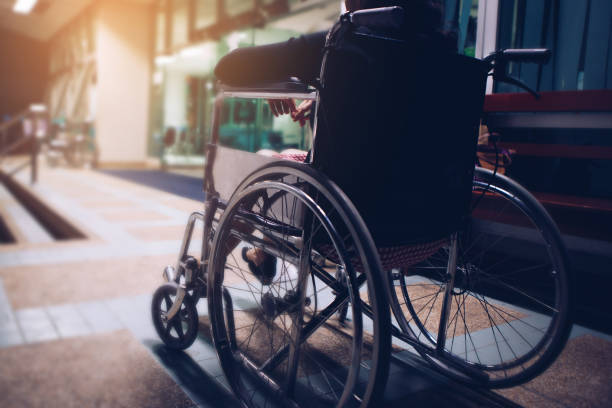 Woman sitting on wheel chair at hospital in the night stock photo