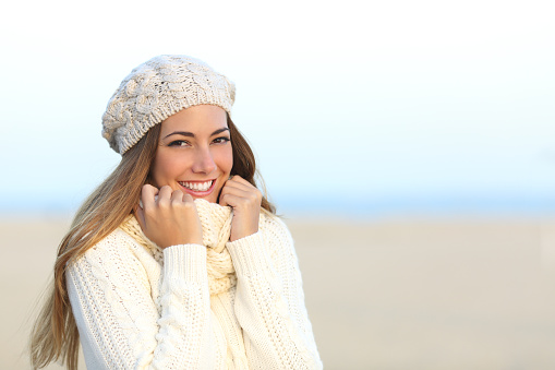 Woman smiling warmly clothed in winter stock photo