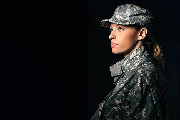 Woman soldier Portrait of beautiful woman soldier isolated on black background military uniform stock pictures, royalty-free photos & images