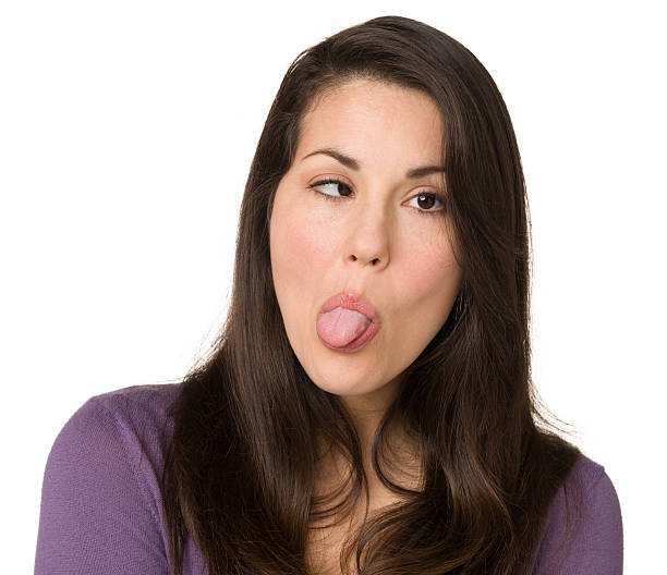 Woman Sticking Out Tongue, Crossing Eyes stock photo.