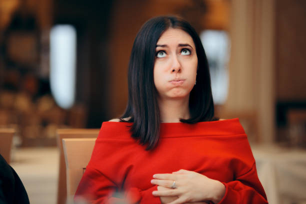 Woman Suffering a Stomachache after Eating in a Restaurant Girl with hands on her abdomen suffering after eating too much full stock pictures, royalty-free photos & images