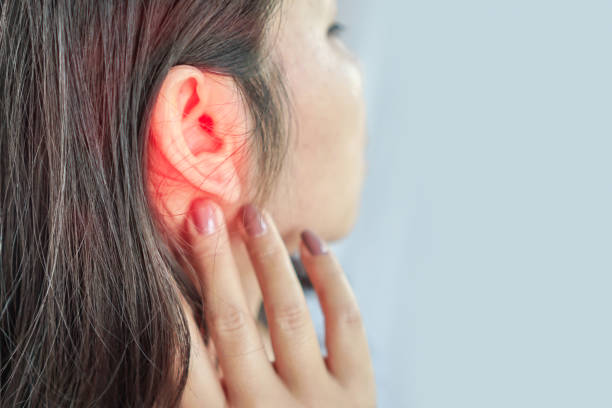 woman suffering from ear pain , Tinnitus concept stock photo