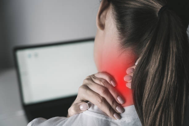 Woman suffering from neck pain after working on laptop Woman suffering from neck pain after working on laptop. High quality photo neck pain computer stock pictures, royalty-free photos & images