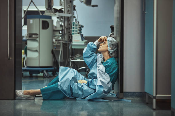 Woman surgeon looking sadness fatigue after surgery copyspace stress depression guilt unhappy problem worker medicine healthcare emotions Woman surgeon looking sadness fatigue after surgery copyspace stress depression guilt unhappy problem worker medicine healthcare emotions. tired stock pictures, royalty-free photos & images