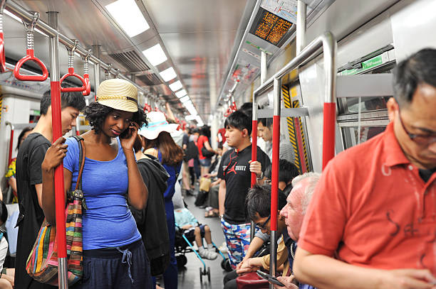 Woman talking on phone in the subway train stock photo