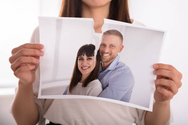 Woman Tearing Photo Of Happy Couple Close-up Of A Woman's Hand Tearing Photo Of Happy Couple couple divorce photos stock pictures, royalty-free photos & images