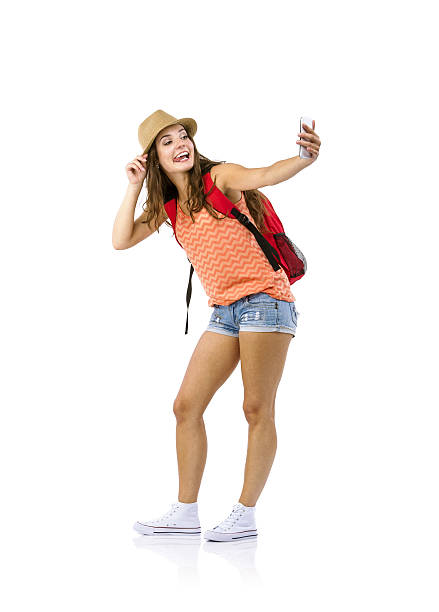 Woman tourist taking selfie Female tourist taking selfie with cell phone isolated on white background tourism photos stock pictures, royalty-free photos & images