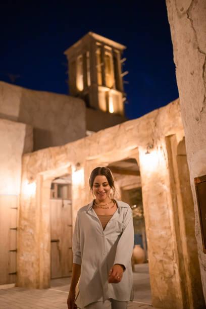 Woman tourist walking in Al Seef Meraas Dubai - old historical district with traditional Arabic architecture stock photo