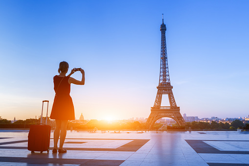 Woman traveler taking photo of Eiffel Tower from Trocadero