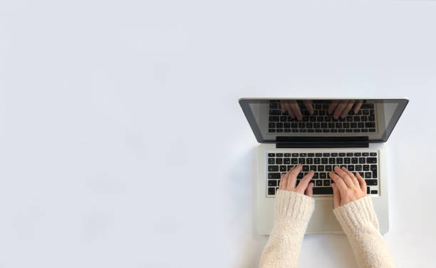 Woman typing on laptop. White Background fall, typing, computer, laptop , top view, cute, girl, arms,winter, white, blank,mac typing on laptop stock pictures, royalty-free photos & images