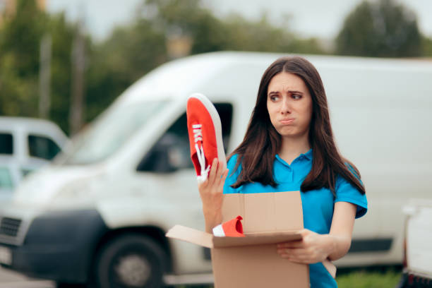 Woman Unsatisfied with Internet Order Receiving Bad Shoes Customer unhappy with quality of online internet order disappointment stock pictures, royalty-free photos & images