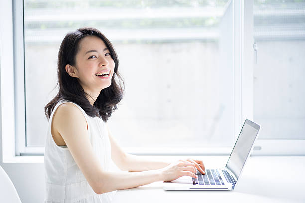 Woman using a laptop stock photo