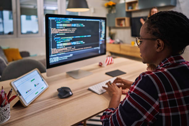 IT woman using COVID-19 lockdown to finally finish coding for a new software stock photo