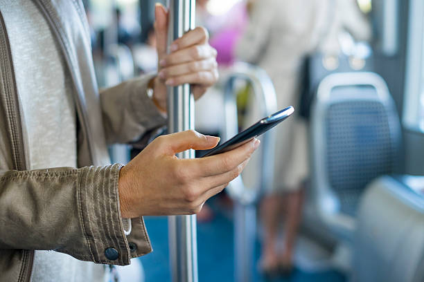 Woman using her cell phone on bus. Tramway. Sms, message stock photo