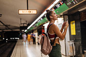 istock Woman using smartphone at subway station 1394945019