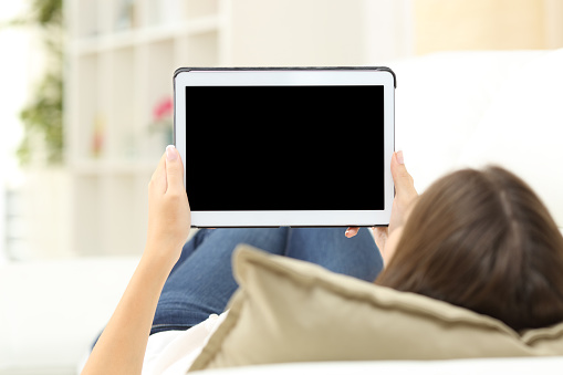 Woman using tablet and showing screen stock photo