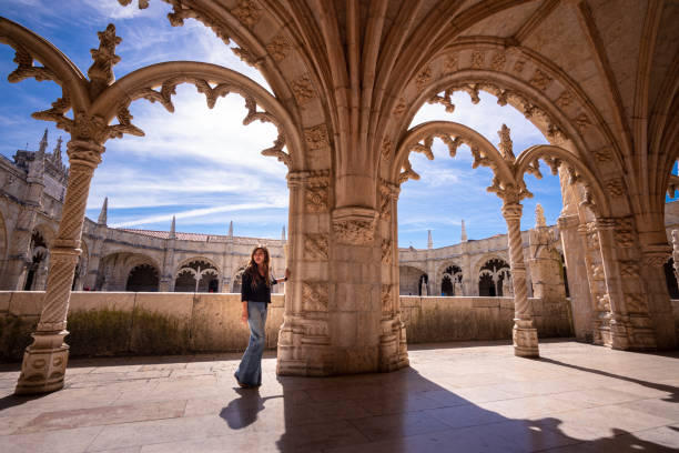 woman visiting cloisters of jeronimos monastery in lisbon, portugal - people portugal imagens e fotografias de stock