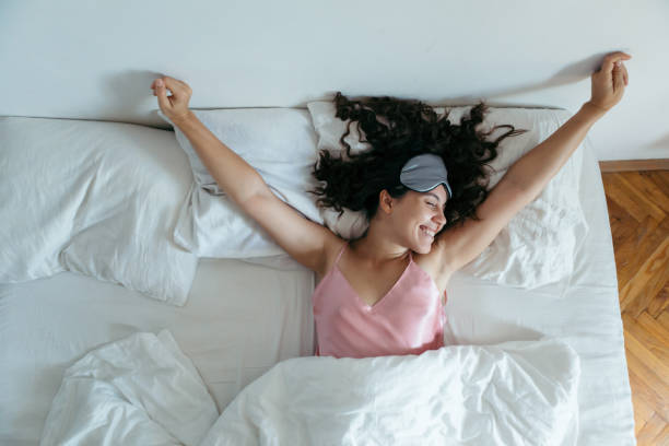 woman waking at the bright morning. sleeping mask woman waking at the bright morning. sleeping mask white sheets eye mask stock pictures, royalty-free photos & images