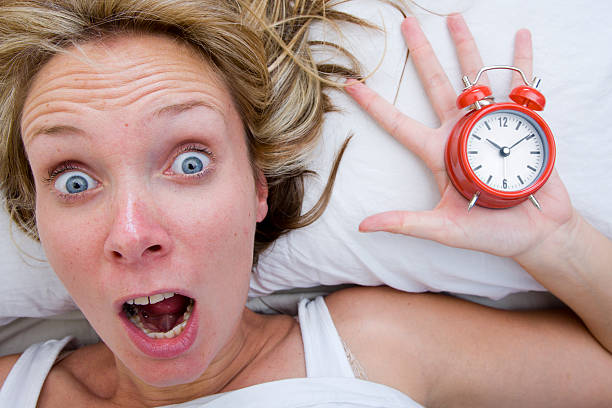 Woman waking up Late stock photo