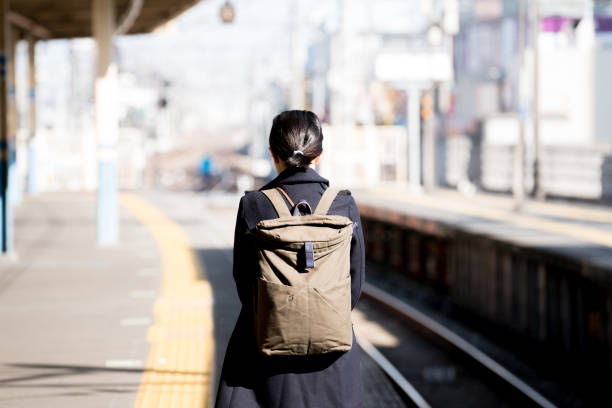 Woman walking at station stock photo