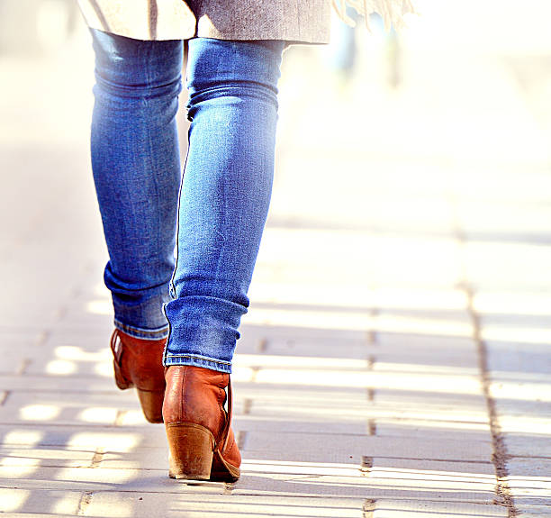 Woman walking into bright light (future?) stock photo