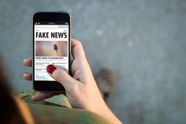 Woman walking smartphone fake news stock photo