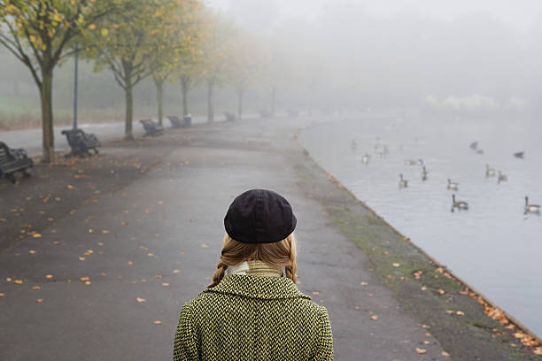 Woman walking through park  20th century style stock pictures, royalty-free photos & images