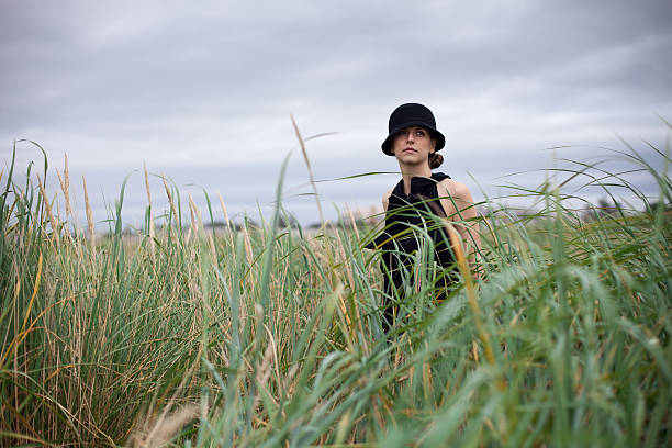 Woman walks in beach grass stock photo